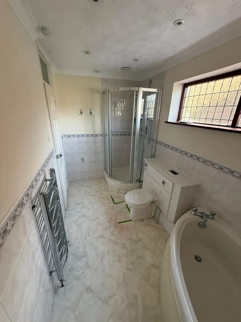 Large bathroom before, with a corner bath and a corner shower enclosure